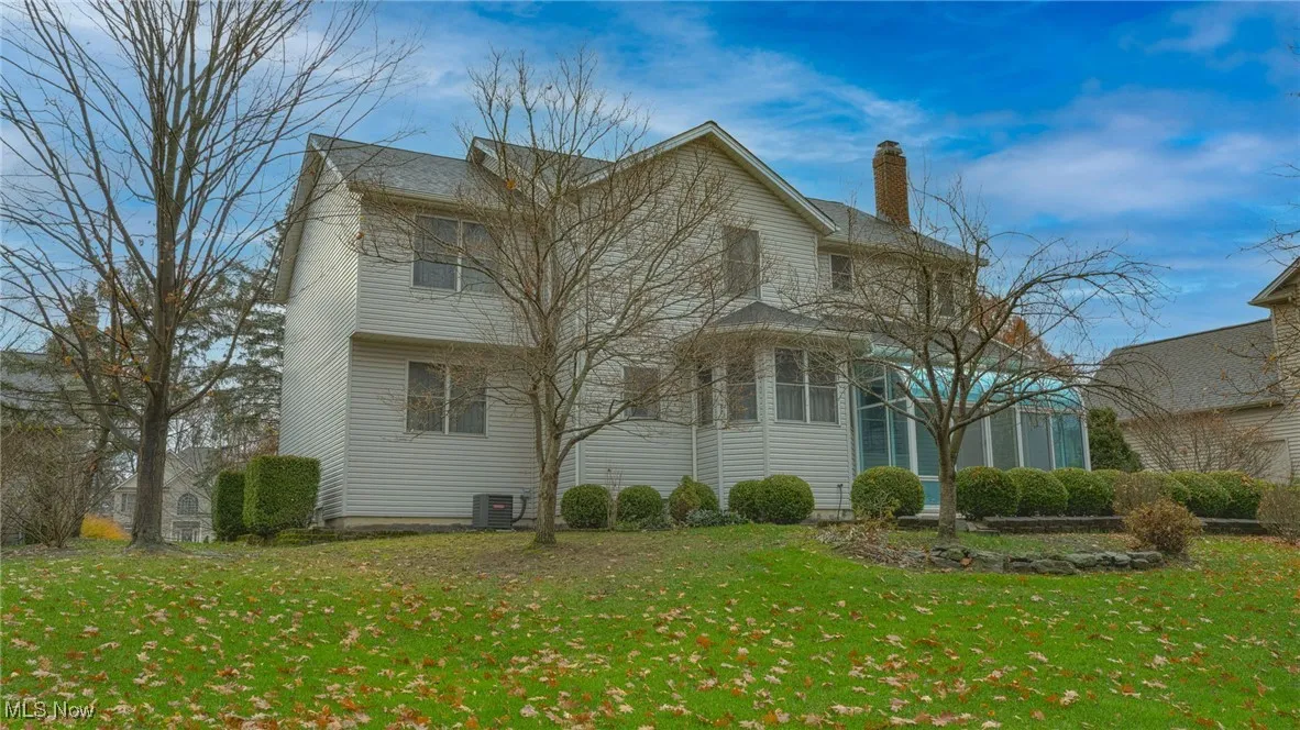 Back of house featuring a yard and a chimney