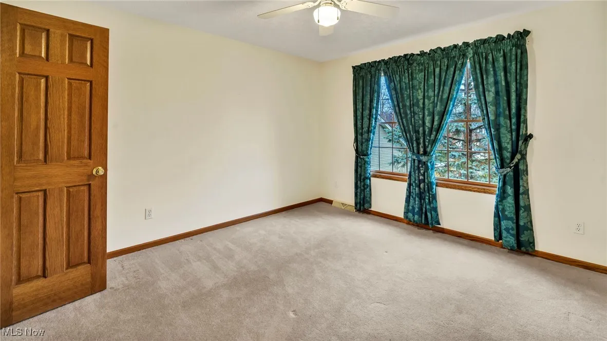 Empty room featuring light carpet