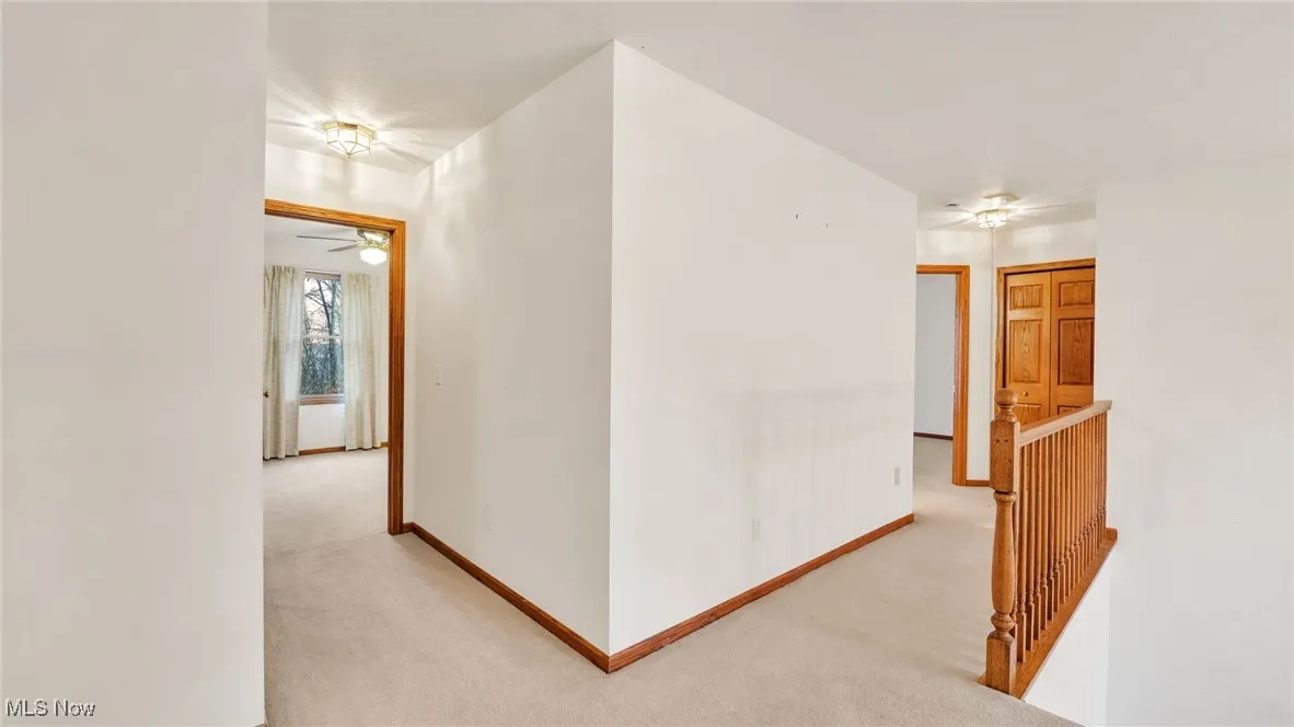 Second floor hall with light carpet