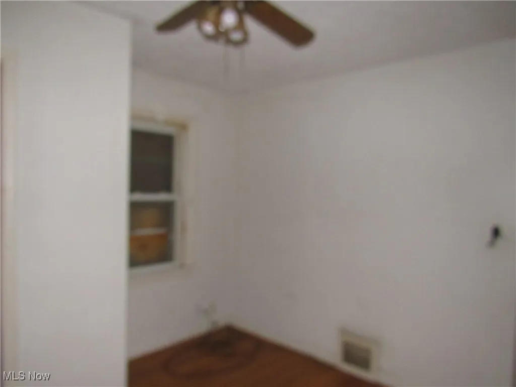 Unfurnished room featuring a ceiling fan