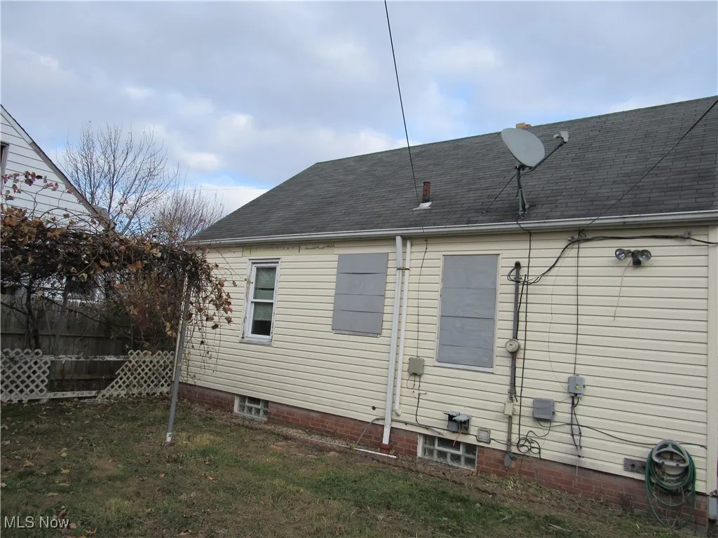 Back of house with roof with shingles
