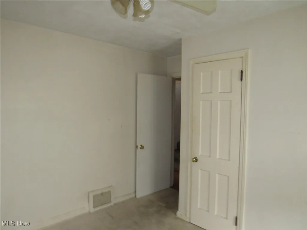Unfurnished room with a ceiling fan