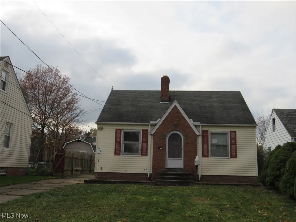 English style home featuring a chimney and roof with shingles