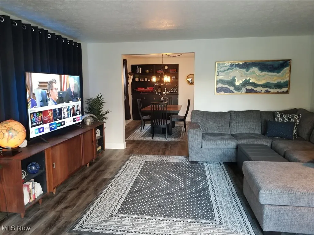 Living area with dark wood-type flooring