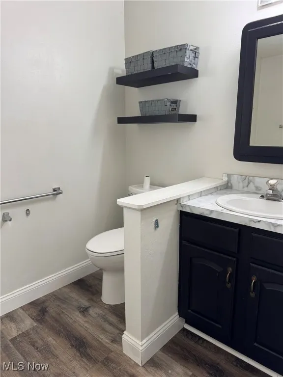 Bathroom featuring vanity and dark wood finished floors