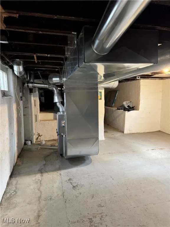 Basement featuring heating unit