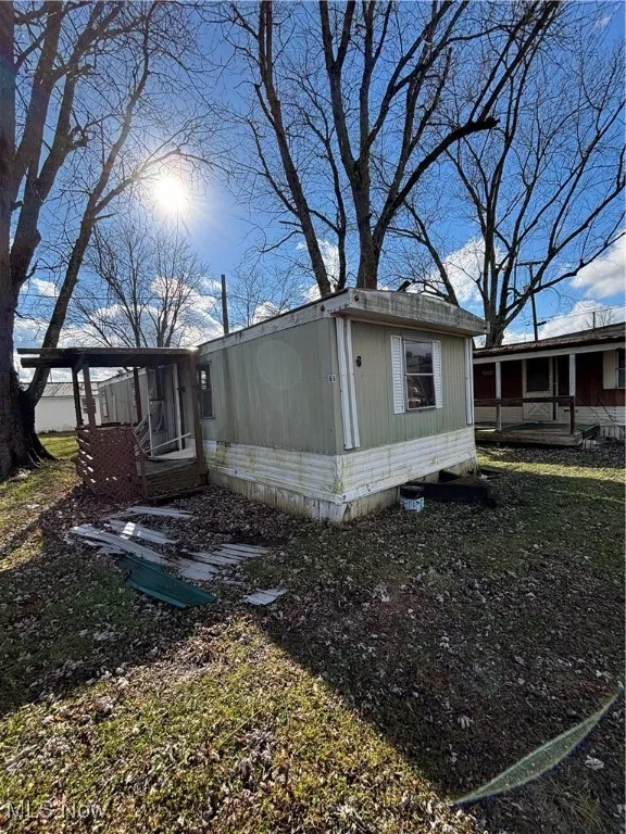 View of side of property featuring a sunroom