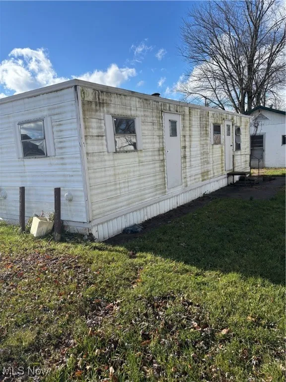 View of home's exterior featuring a yard