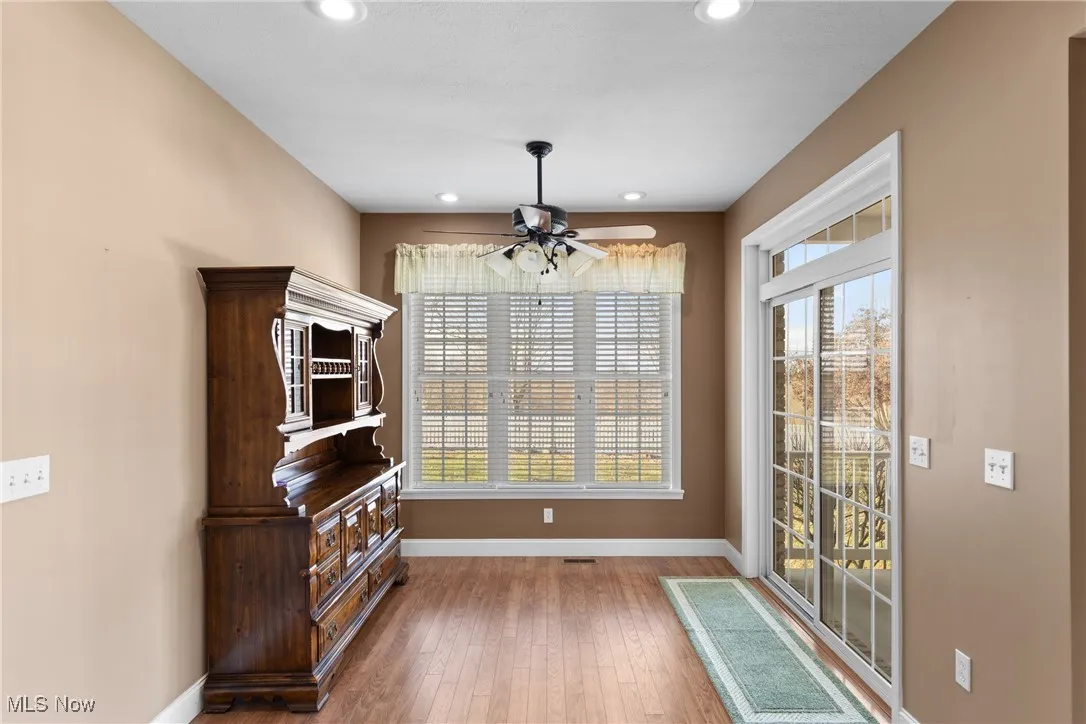 Morning room featuring healthy amount of natural light, hardwood / wood-style flooring, a ceiling fan, and recessed lighting