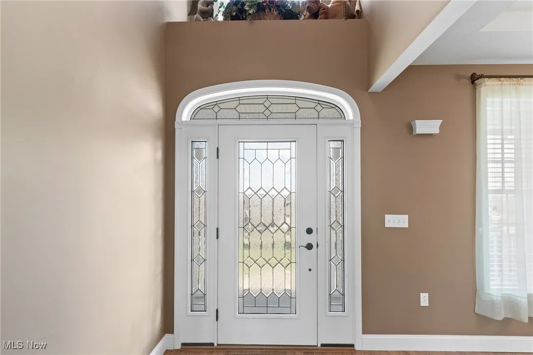 Foyer entrance with plenty of natural light and wood finished floors