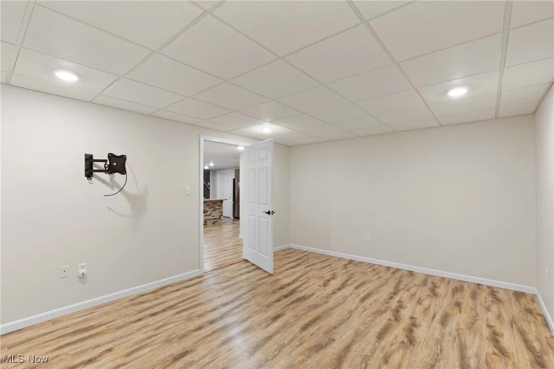 Family room with a paneled ceiling, LVT finished floors, and recessed lighting