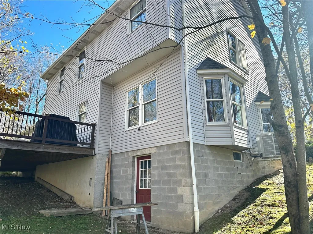 View of home's exterior with a deck