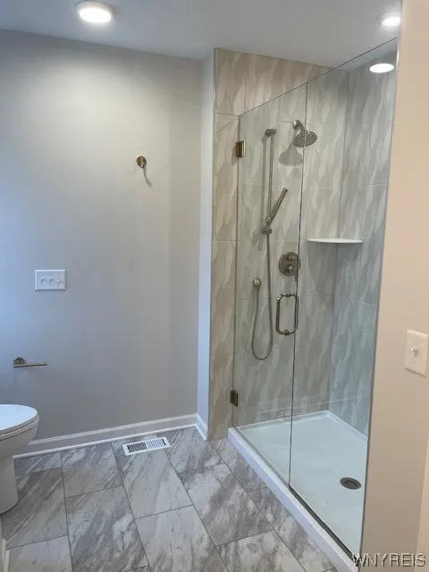 Stunning ceramic tile walk in shower in the primary bath