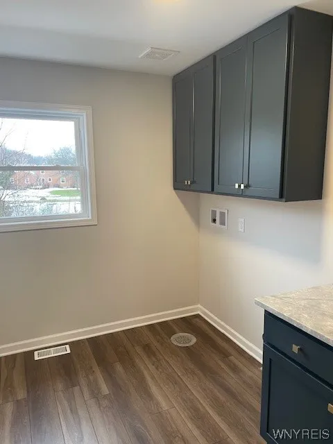 Second floor laundry room with cabinets