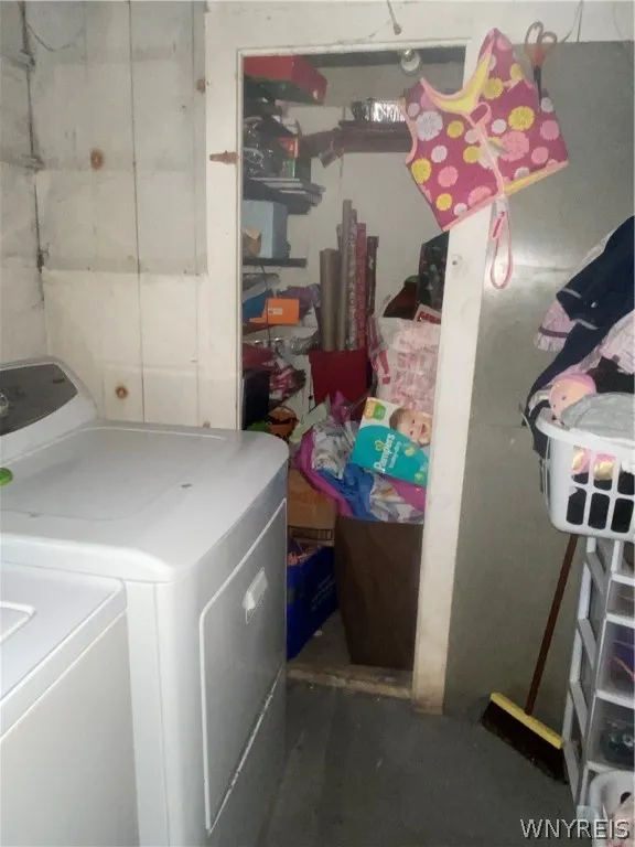 Washing machine in basement with storage area