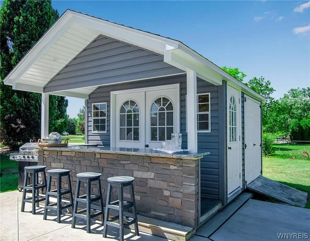 Pool house with granite bar & large storage shed. Electrically wired & perfect spot for an outdoor fridge