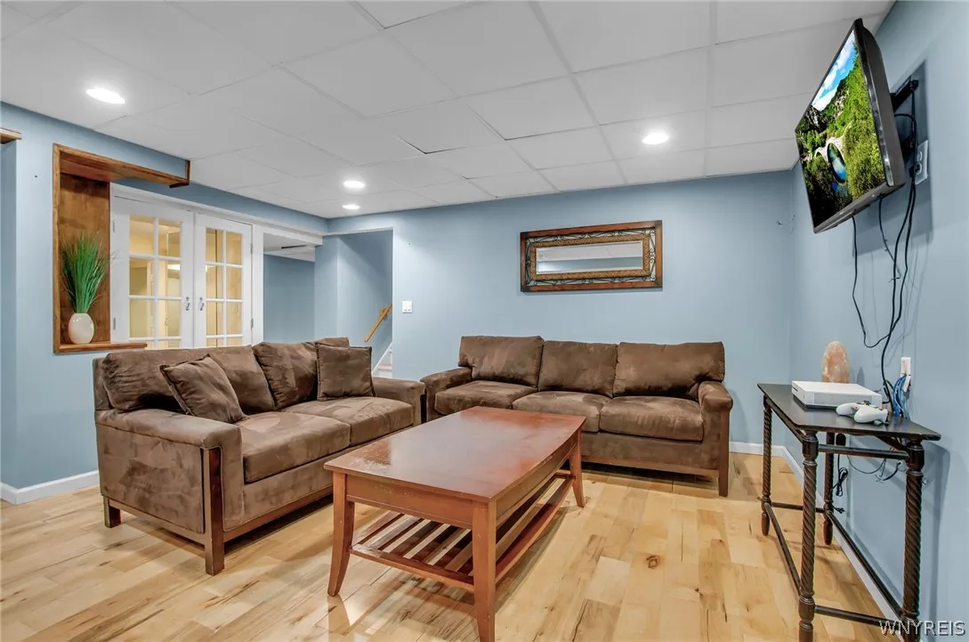Basement living room with staircase leading to garage