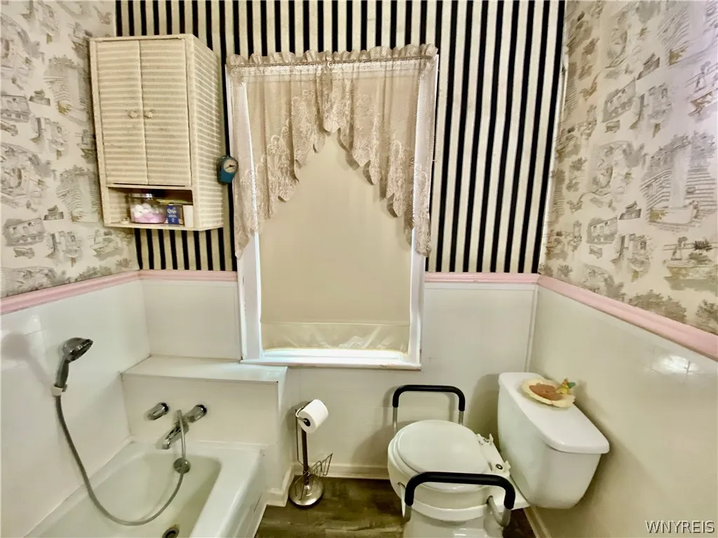 Bathroom has a hand held shower.