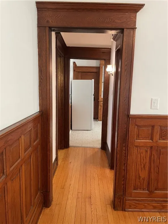 View from dining room down hallway into bathroom, second bedroom and then into kitchen