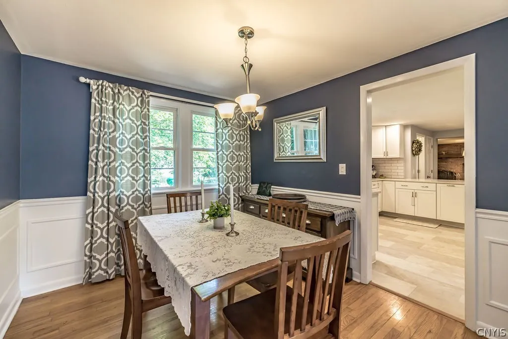 The dining room is a delight with chairrail and picture frame molding accented by calming blue toned walls and pewter chandelier.