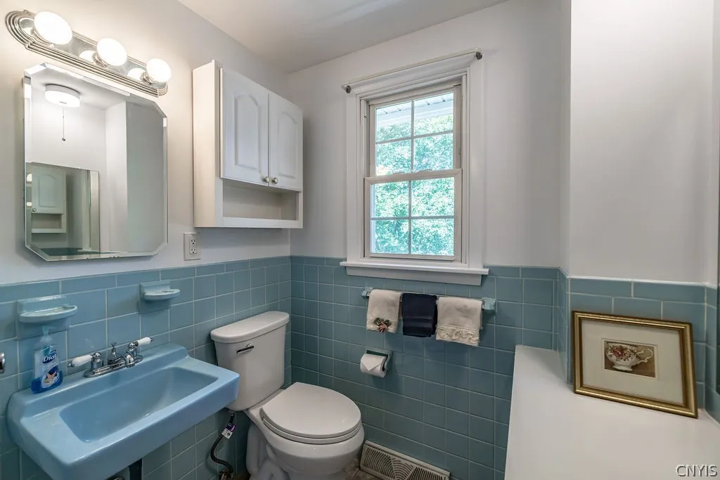 Baby blue walls, sink, soapdish and toothbrush holders are fun accents in the rest of this updated powder room.