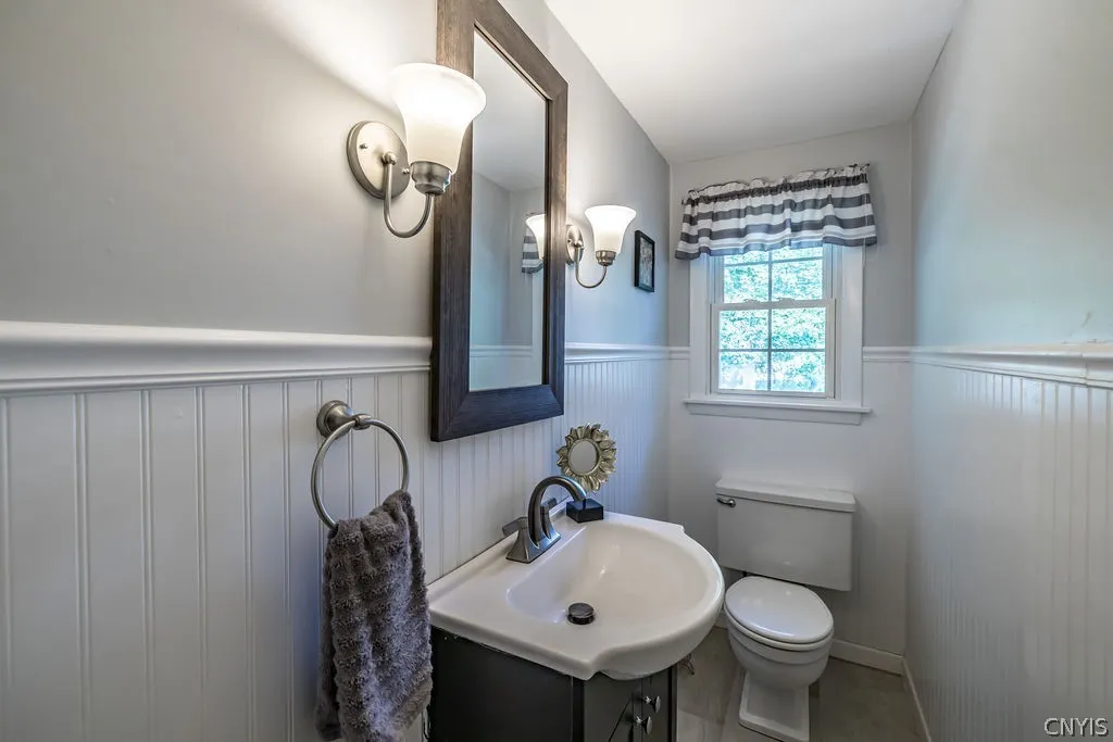 The updated powder room offers beadboard walls and chairrail molding.