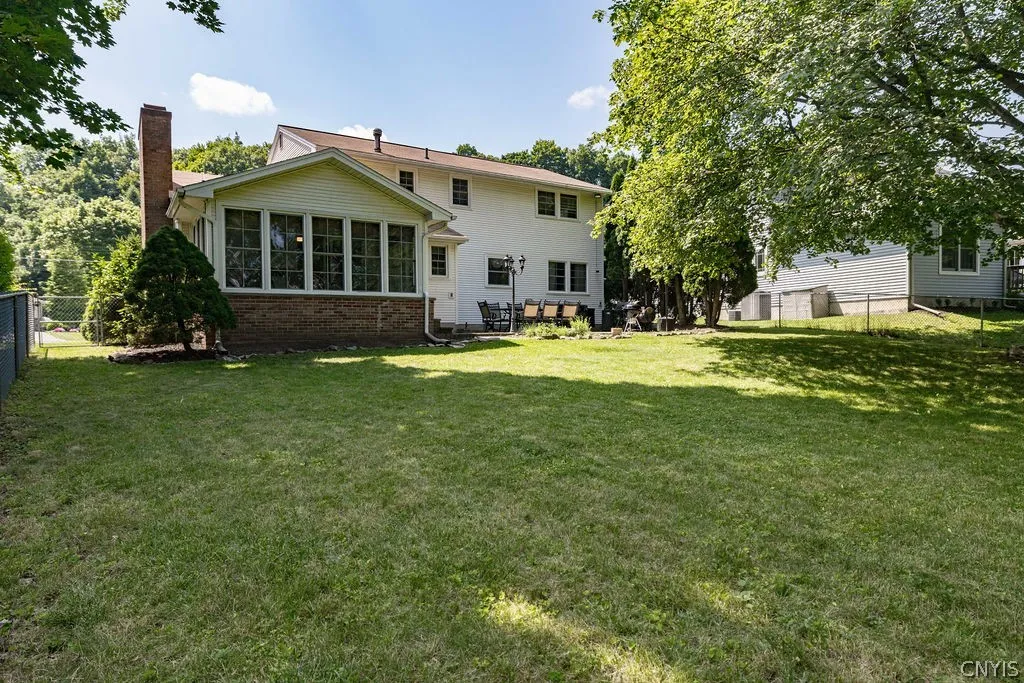 Tbe extensive fenced backyard offers shade, sunshine and privacy.