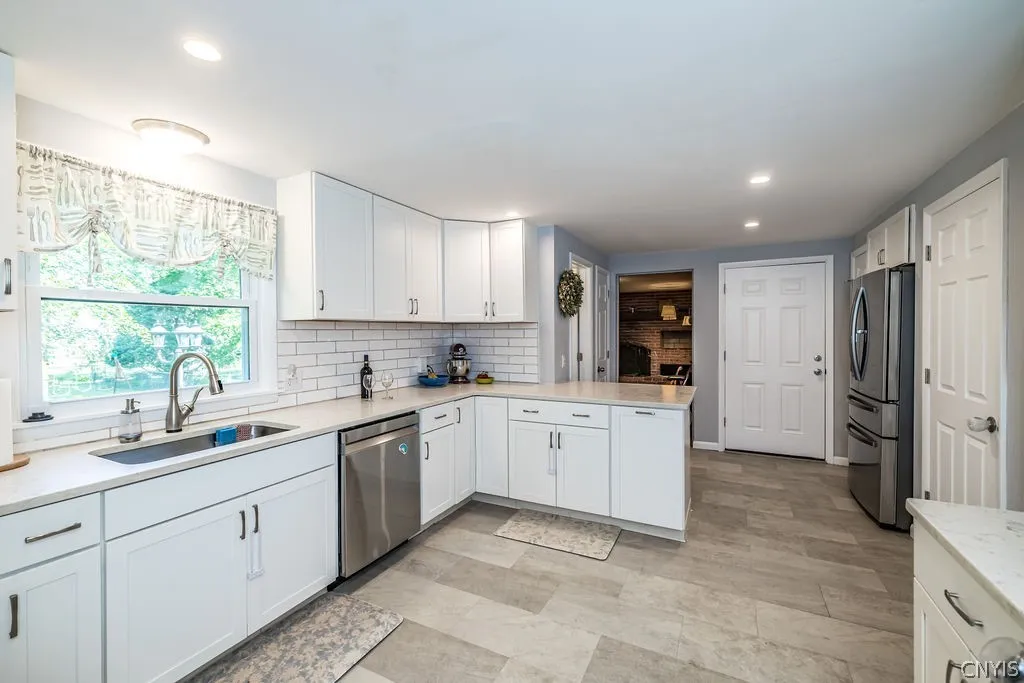 You will love this bright white kitchen with solid surface countertops, luxury vinyl tile flooring, breakfast bar, ceramic backsplash, stainless steel appriances and great space for preparing family and holiday meals.
pantry closet