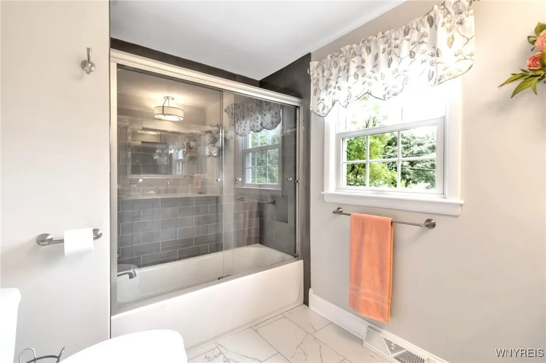 2nd floor remodeled Bath with ceramic tiled shower with glass sliding dr