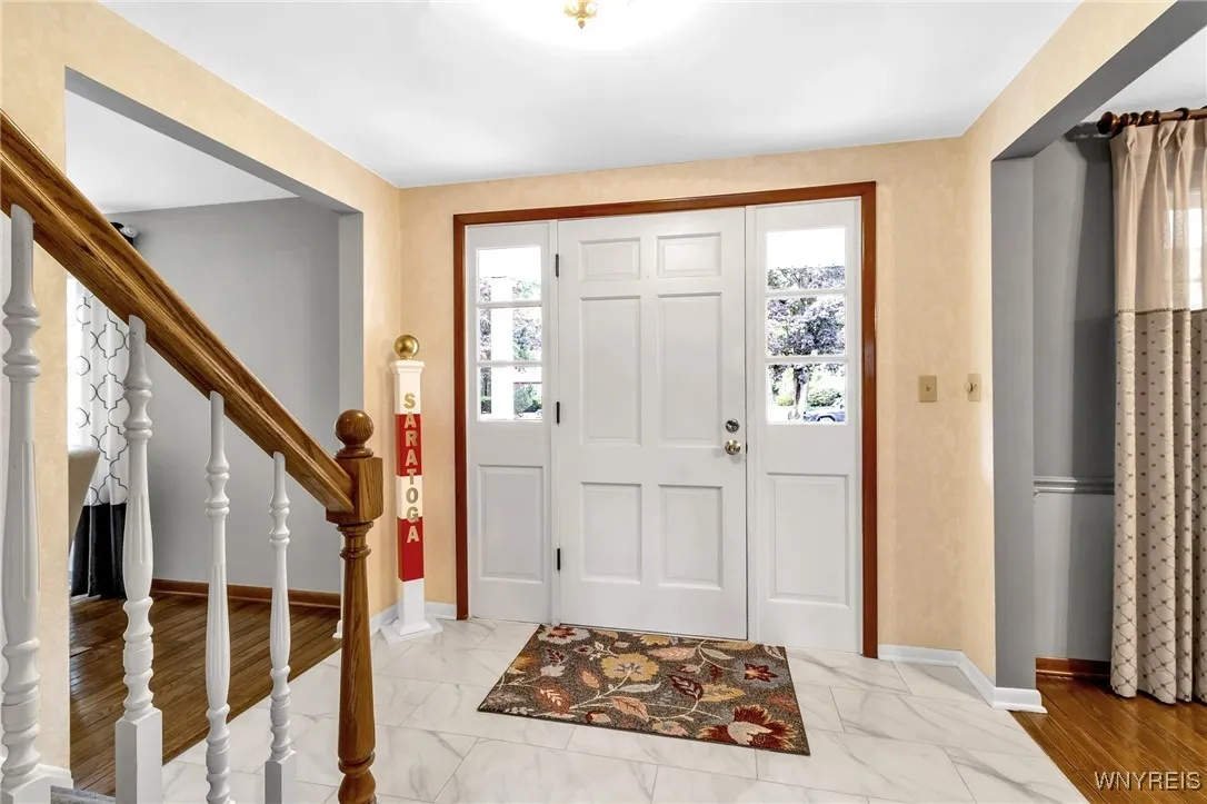 Spacious foyer. Front door with side lights