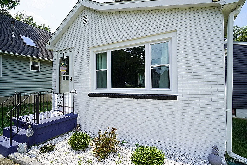 nice gardens along the front and side of the home