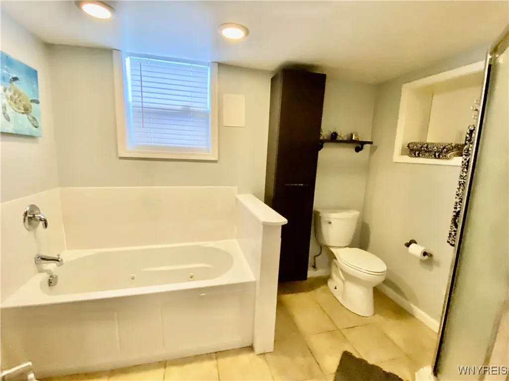 Lower level bathroom has a  jetted tub.