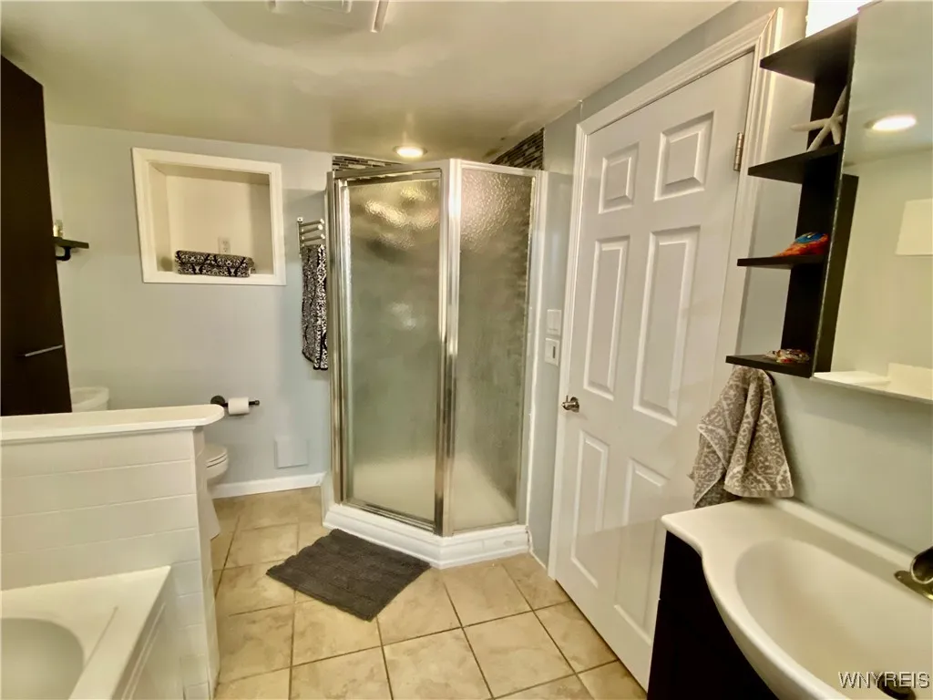 Lower level bathroom has a separate shower.