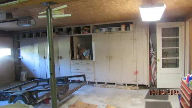 One side of garge showing storage other side has similar units