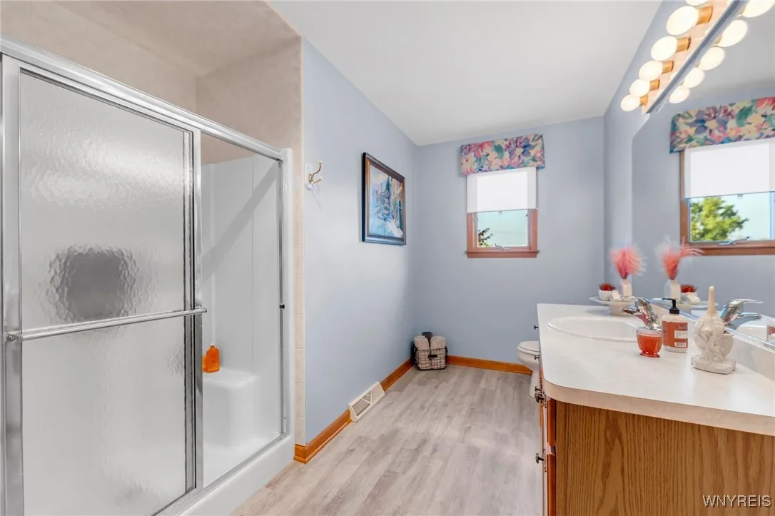 Hallway bath with large shower and seat!  A new floor here too!