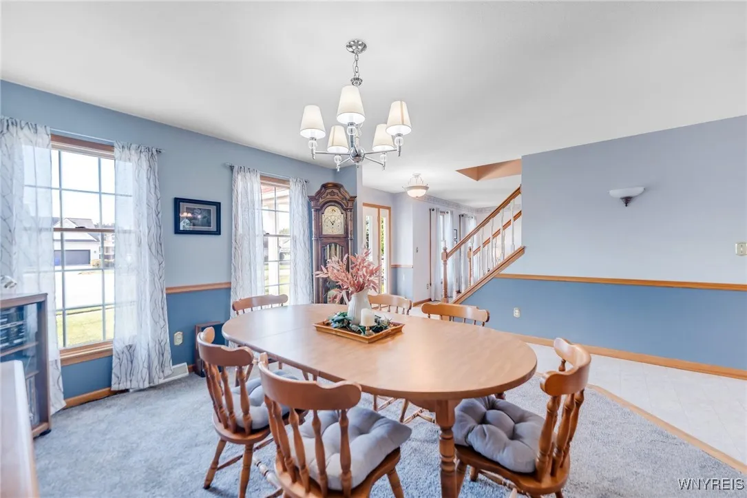 Formal Dining Room off the front Foyer with chair rail trim, flows directly into Kitchen.