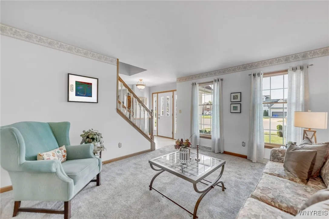Formal Living Room with neutral carpet flows off the Foyer entance.