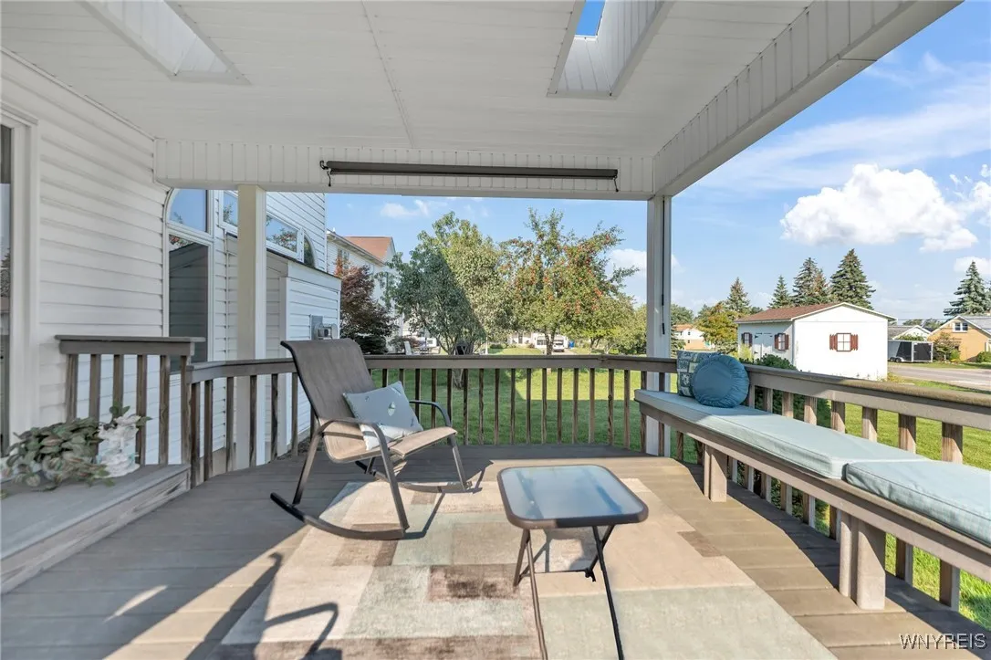 Maintenance free covered deck with skylights and bench seating.  Picture yourself enjoying your morning coffee here!