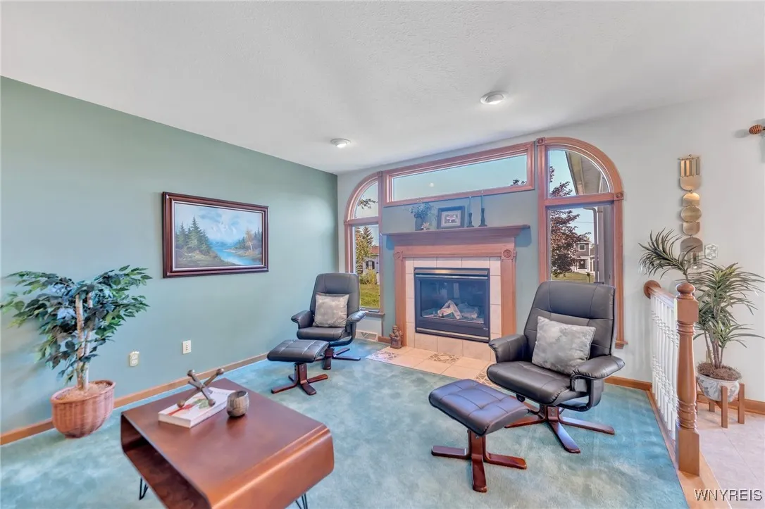 Stunning Family Room with gas fireplace flanked by windowson all sides...This home is truly bright.
