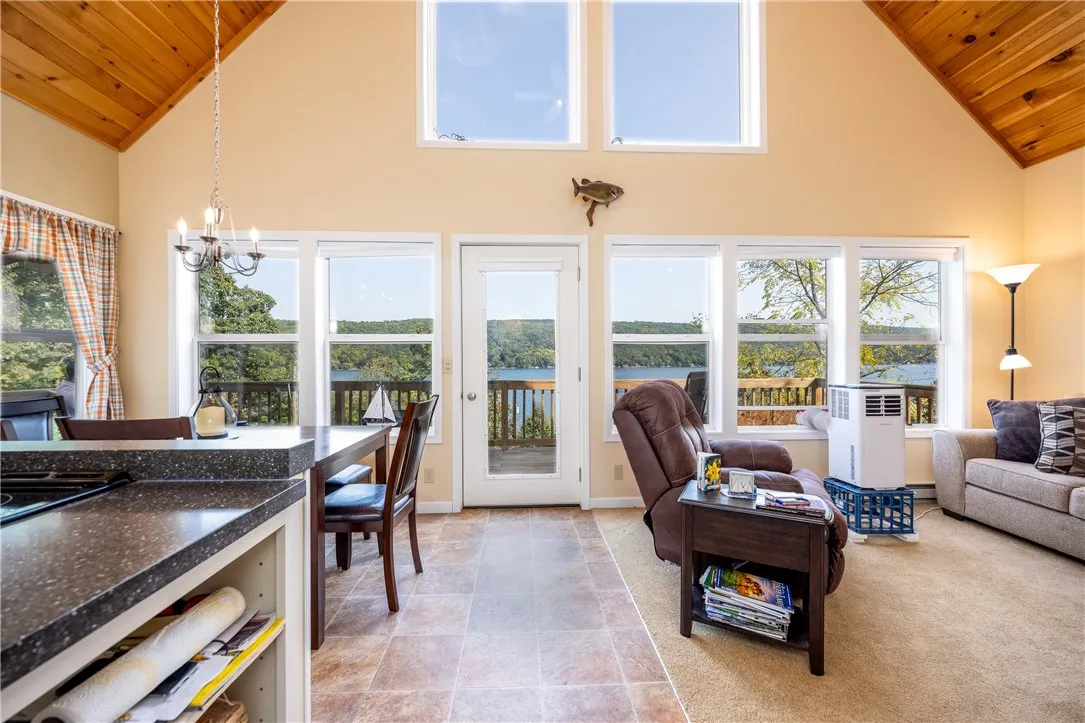 SPECTACULAR TWO STORY GREAT ROOM WITH WOOD CEILINGS & WALL OF WINDOWS FOR PANORAMIC LAKE VIEWS!