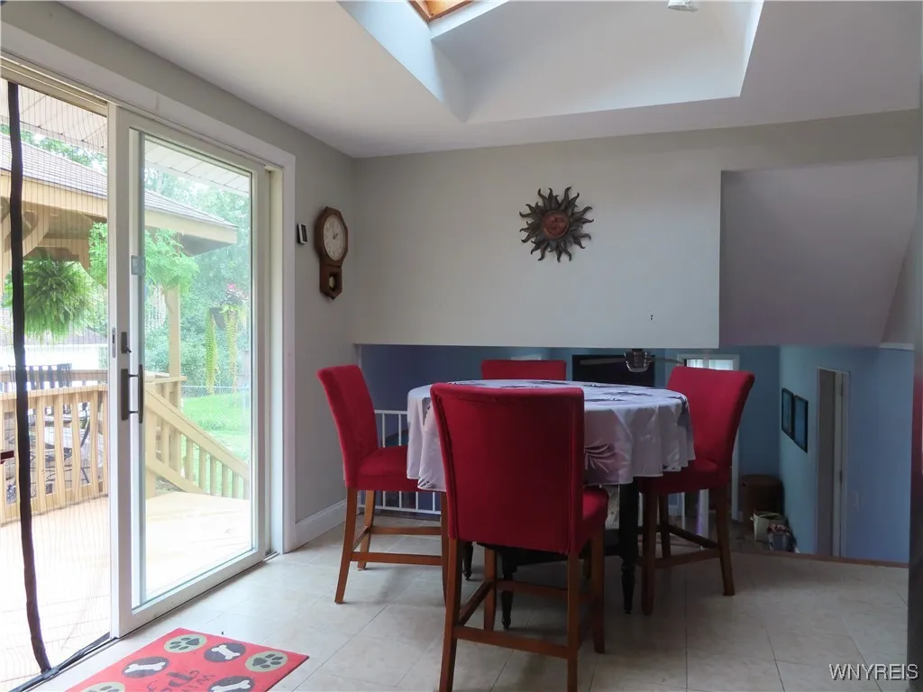 Kitchen dining area with large sliding glass door out to deck