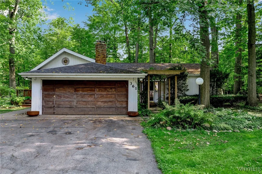 Garage is located on the Woodland Drive side