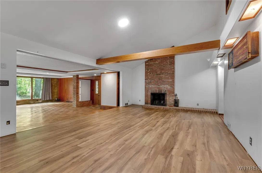 Updated flooring in the living room accented with wood beam