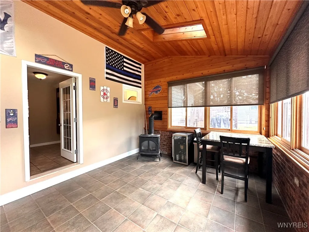 Party room with wood burning stove and tiled floor