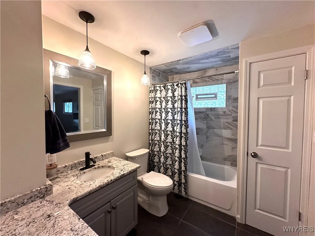 Full bath with tiled tub shower