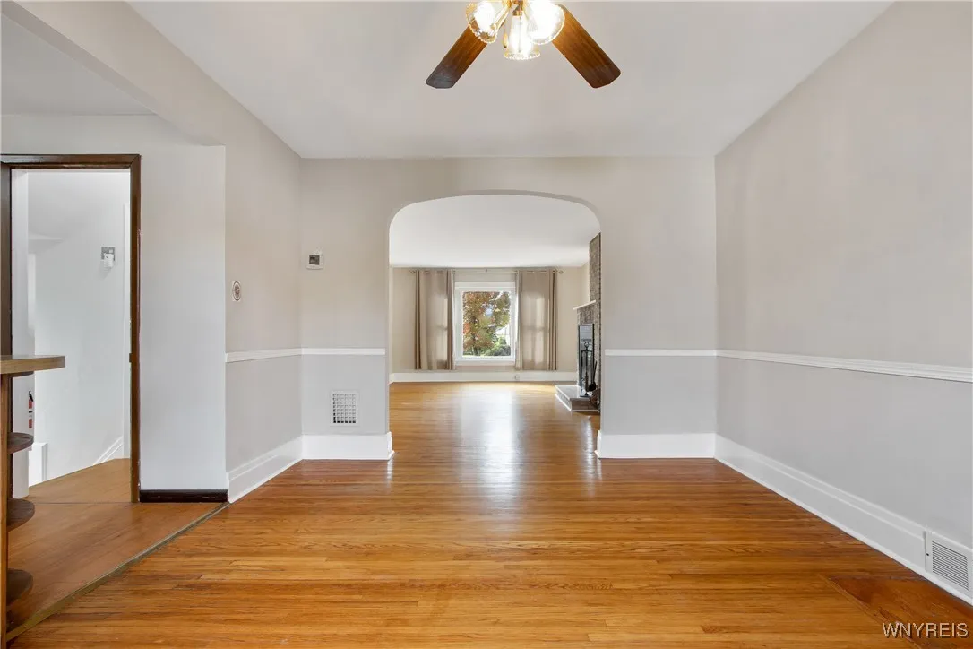 dining room view into living room, kitchen on left/hardwood floor