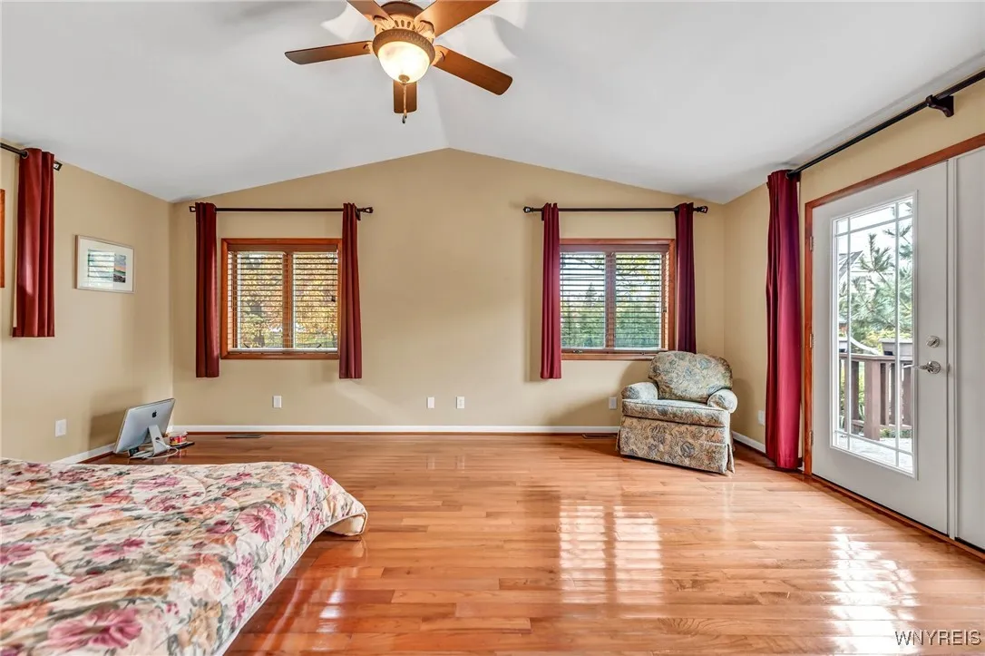 Primary bedroom with cathedral ceilings and French door to the patio.