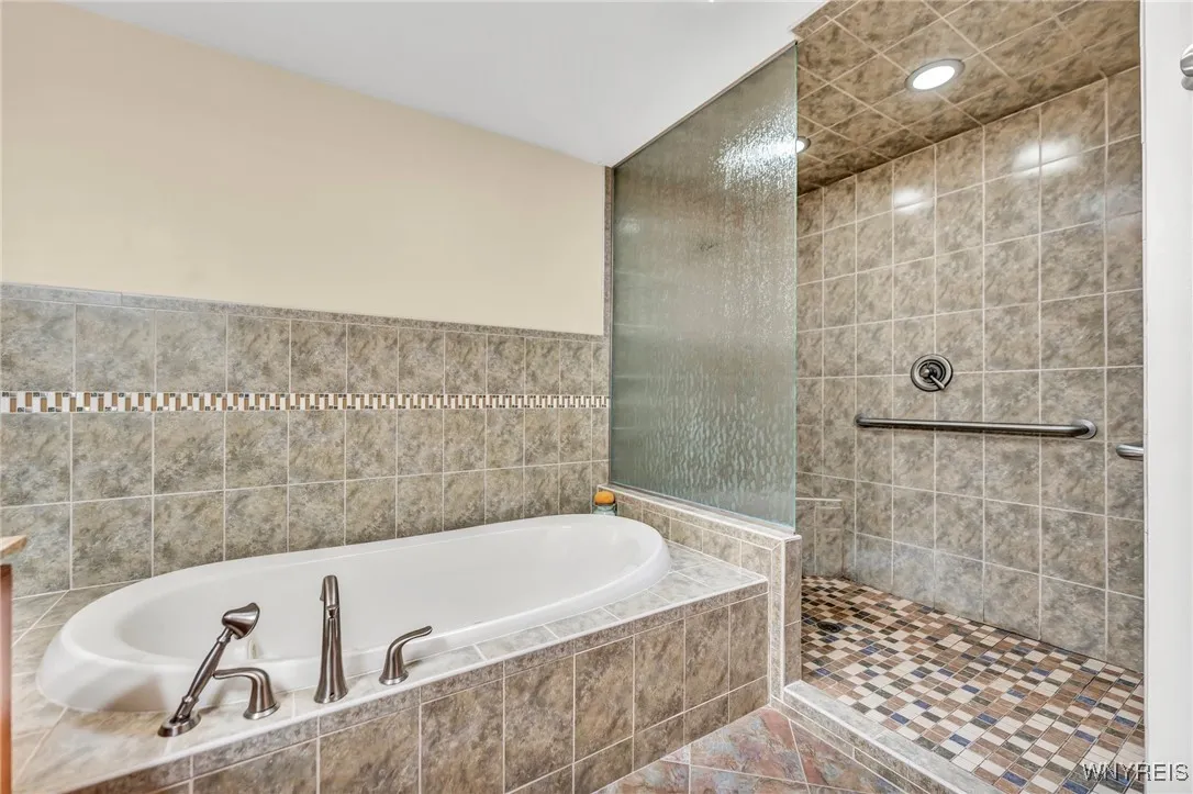 Primary bath with very large shower and jacuzzi tub.