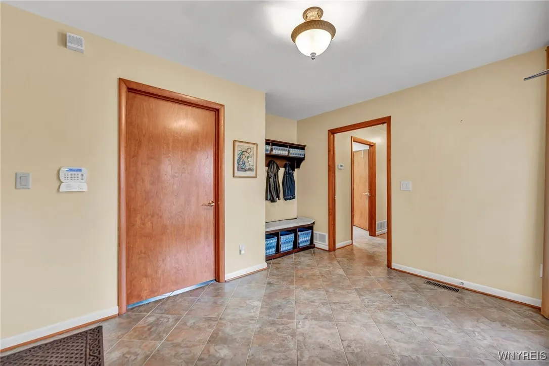 Large mudroom area includes entry to garage, laundry room and primary suite.