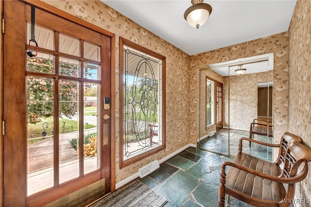 Large light filled foyer with closet.